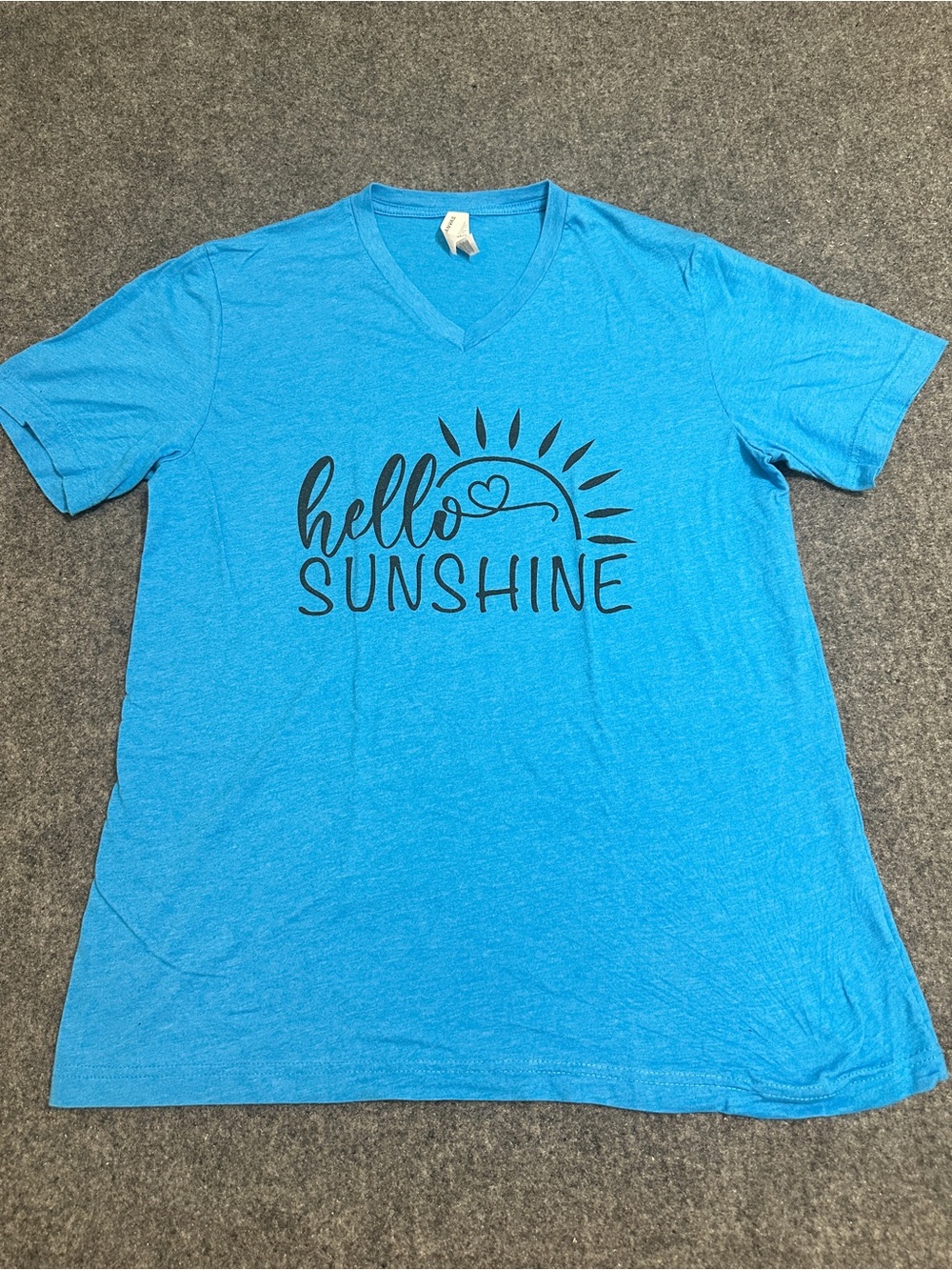 Bright blue short-sleeve V-neck t-shirt featuring a black graphic